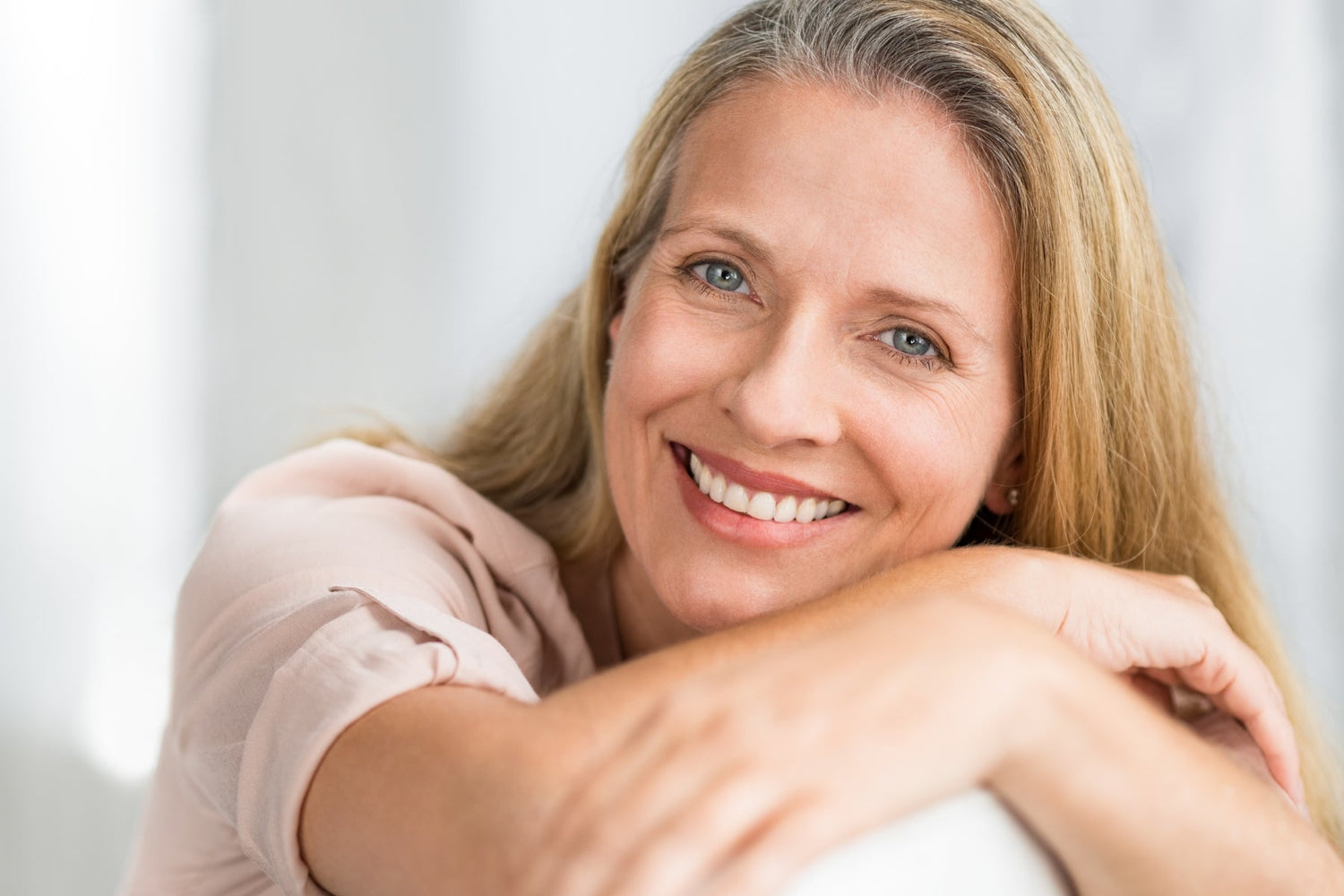 mature woman smiling with crows feet