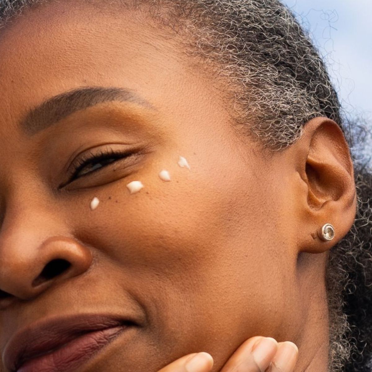Woman applying ManukaRx Vitamin C Eye Cream