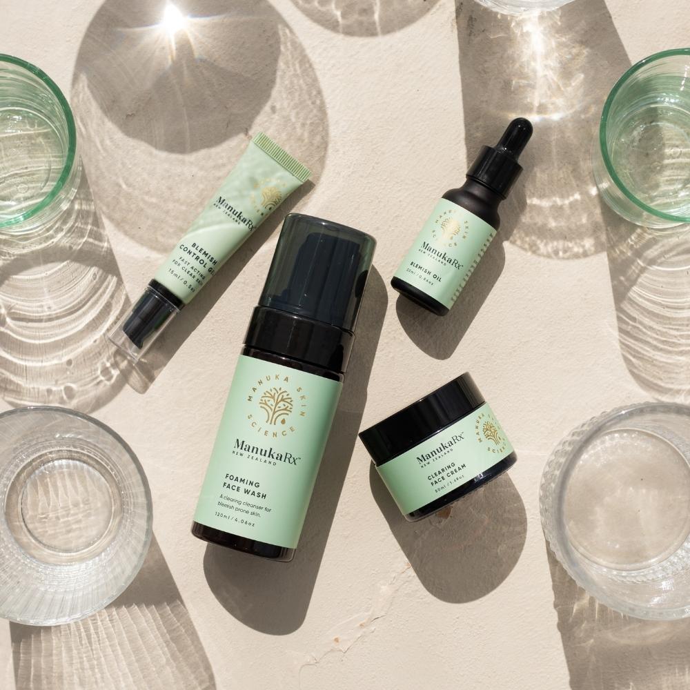 ManukaRx Ultimate Blemish Control Routine set surrounded by cups of water